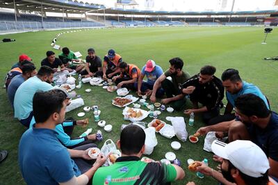 Players breaking their fast before the start of Sharjah Ramadan Cup final. Pawan Singh / The National