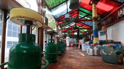 Empty gas cylinders converted to barstools are part of the decor at the Art House Cafe in the Khalidiyah area of Abu Dhabi. Ravindranath K / The National