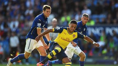 Alex Oxlade-Chamberlain of Arsenal takes on Dean Hammond and Paul Konchesky of Leicester City during their 1-1 draw in the Premier League on Sunday. Laurence Griffiths / Getty Images