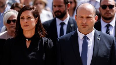 Israeli Prime Minister Naftali Bennett and his wife, Gilat, take part in the ceremony marking Holocaust Remembrance Day at Warsaw Ghetto Square at the Yad Vashem memorial in Jerusalem. AP