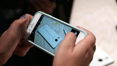An attendee takes a picture of the new Nexus 5X phone. Justin Sullivan / Getty Images / AFP