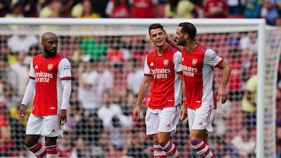 Arsenal's Granit Xhaka, centre, is congratulated after scoring.