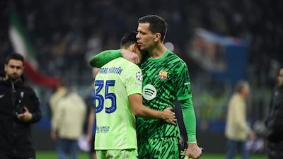 Barcelona's Polish goalkeeper Wojciech Szczesny comforts Gerard Martin. AFP