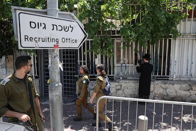 A utra-Orthodox Jewish man at the Israeli army recruitment office, in Jerusalem, with Israeli soldiers in the foreground. EPA