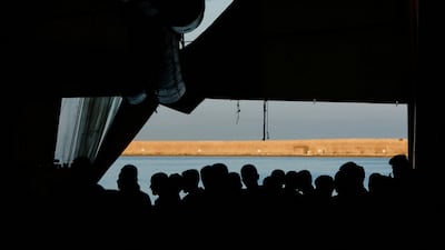 Migrants wait to disembark from the Geo Barents rescue ship, operated by Medecins Sans Frontieres, in Livorno port, Italy. Reuters