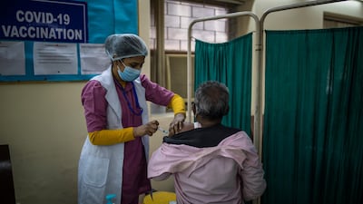 A health worker administers a Covid-19 vaccine to a municipal worker at a private hospital in New Delhi, India. AP Photo