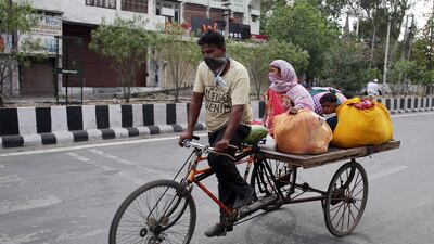 A migrant worker along with his family members rides on a cart, amid the ongoing Covid-19 coronavirus emergency lockdown in India. The government on Tuesday announced a $266bn stimulus package to support the country's economy. EPA