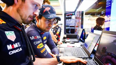 Sergio Perez of Mexico with Oracle Red Bull Racing team members prepares for the Abu Dhabi race. Getty