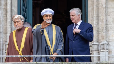 Sultan Haitham and King Philippe stand on the City Hall balcony. Getty Images