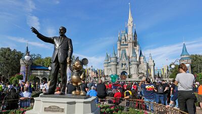 A statue of Walt Disney and Micky Mouse near the Cinderella Castle at the Magic Kingdom of Walt Disney World in Lake Buena Vista, Florida. AP