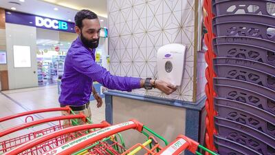 Extra hand sanitisers stations have been fitted at trolley pick up and drop off zones at Lulu Hypermarket. Victor Besa / The National