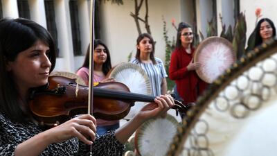 Young Yazidi and Muslim women, part of the musical group "40 Plaits," rehearse a traditional Kurdish song accompanied by the Daf, a large Kurdish frame drum, in a community centre in Dahuk, about 260 miles (430 kilometers) northwest of the Iraqi capital Baghdad. AFP