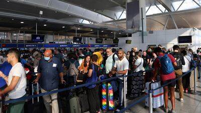 People queue to drop bags at New York's John F Kennedy International Airport. Reuters