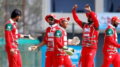 Oman celebrate after taking a wicket against Nepal. Subas Humagain for The National