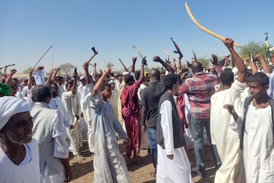 Supporters of the Sudanese armed popular resistance, which backs the army, wave automatic rifles, axes and batons as they rally in Gedaref on March 3, 2024. AFP