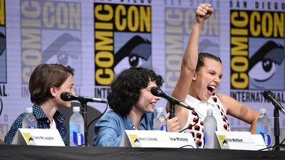 Millie Bobby Brown, right, gestures as from left, Noah Schnapp, and Finn Wolf look on at the Stranger Things panel on day three of Comic-Con International. Richard Shotwell / Invision / AP