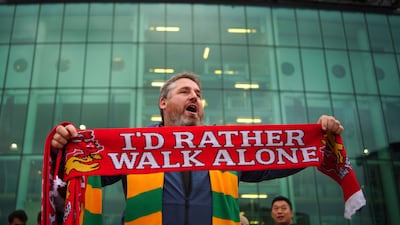 A man sells scarves outside the Old Trafford ground. PA