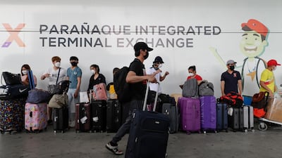 Seafarers, who got quarantined as they arrived in the Philippines weeks ago, wait for their free ride back to their provinces, in Paranaque, Metro Manila, Philippines. AP Photo