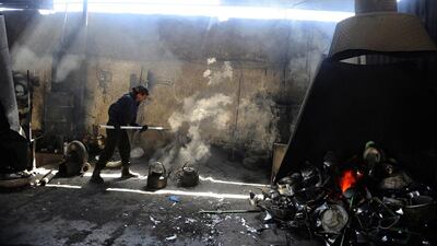 An Afghan labourer works at an aluminium workshop in Herat.