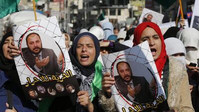 Protesters from the Islamic Action Front, carry pictures of the Jordanian Muslim Brotherhood's deputy leader Zaki Bani Rsheid during a demonstration to show their anger at the political arrest in Amman on November 28, 2014. Muhammad Hamed/Reuters