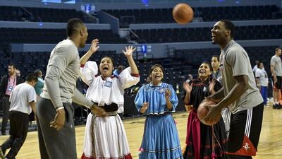 Dwight Howard, left, and Trevor Ariza, right, of the Houston Rockets conduct a clinic on Tuesday with the Tarahumara women's basketball team in Mexico City. Yuri Cortez / AFP