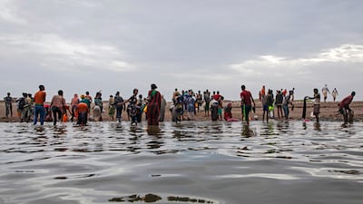 Ethiopian migrants walk on the shores of Ras al Ara in Yemen, after disembarking from a boat. AP