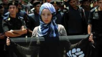 A woman holds a banner during the protests in Cairo yesterday.