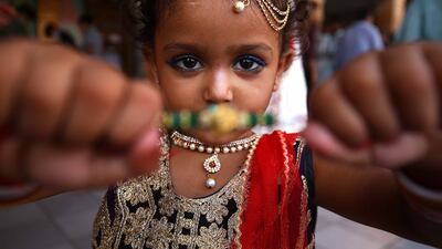 A girl with a rakhi. EPA