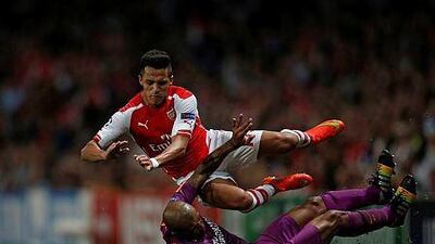 Arsenal striker Alexis Sanchez, top, is tackled by Galatasaray's Brazilian midfielder Felipe Melo during the Uefa Champions League, Group D football match with Galatasaray at The Emirates Stadium in north London on October 1, 2014. Arsenal won the game 4-1. AFP PHOTO / ADRIAN DENNIS