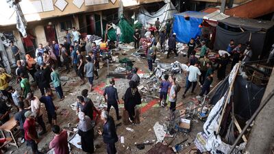 Palestinians react after an Israeli strike hit the Rafidiah school housing displaced people in Deir Al Balah in central Gaza. AFP