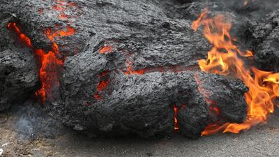 Lava burns across a road in the Leilani Estates subdivision near Pahoa, Hawaii. Caleb Jones / AP Photo