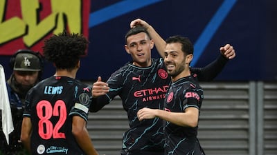 Manchester City's Phil Foden celebrates scoring their first goal with Bernardo Silva and Rico Lewis. Reuters