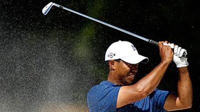 Tiger Woods shows his frustration after a disappointing bunker shot on the 11th hole at Quail Hollow.