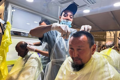A Muslim pilgrim has his hair cut, marking the final step before leaving the state of ihram in Makkah. AFP