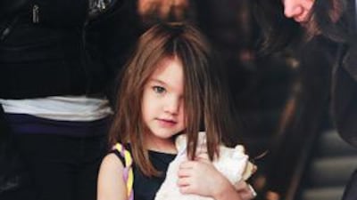 Suri Cruise's parents have said they can't talk her out of wearing her silver high heels.