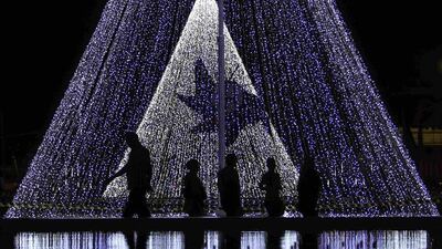 Sri Lanka: People walk past decorations on a street ahead of Christmas day celebrations in Colombo Reuters/Dinuka Liyanawatte