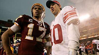 The New York Giants quarterback Eli Manning, right, and the Washington Redskins quarterback Jason Campbell talk after the Giants defeated the Redskins.