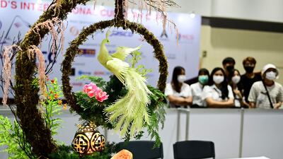 Carvings by Vietnamese citizen Pham Van Dong are displayed in Bangkok.