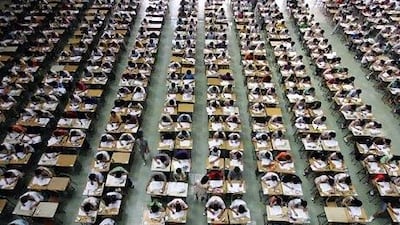 Students take their examination in an exam hall in Dongguan University of Technology, in south China's Guangdong province, July 9, 2007. Around 1,200 students took their English examination in a large hall so as to prevent exam fraud. Picture taken July 9, 2007. REUTERS/China Daily (CHINA) CHINA OUT