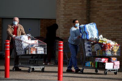 People push full shopping carts outside a supermarket in Watford, Britain. Supermarkets have more mouths to feed this Christmas - with many of the five million or so Britons who normally travel abroad for the festive period staying in the UK. Reuters