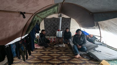 Mr Al Masto with friends in the tent where his family now live. Jindires residents say they desperately need homes, roads, water and a sewerage system