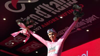 UAE Team Emirates' Tadej Pogacar celebrates on the podium after retaining the pink jersey and a 46-second overall lead. Reuters
