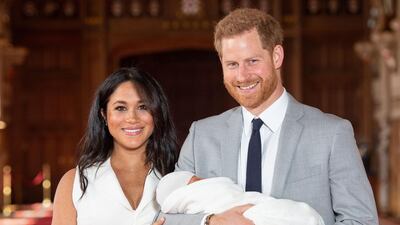 Britain's Prince Harry, Duke of Sussex, and his wife Meghan, Duchess of Sussex, pose for a photo with their newborn baby son, Archie Harrison Mountbatten-Windsor, in St George's Hall on May 8, 2019, two days after his birth. AFP