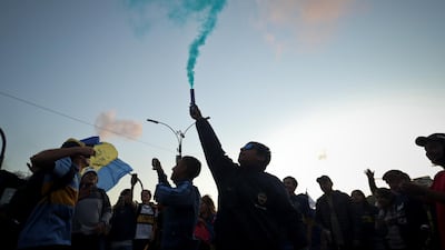 Boca fans light a flare. EPA