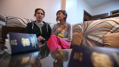 Josephine Abu Assaleh (L) talks with her neice in Damascus on January 30, 2017, after the family was refused entry to the United States and forced to return to Syria. Louai Beshara / AFP