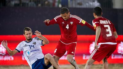 The UAE’s Waleed Beshr, centre, tussles for the ball in the third place playoff against Russia at the Intercontinental Beach Soccer Cup at Kite Beach in Dubai on Saturday. Manuel Queimadelos / Quality Sport Images