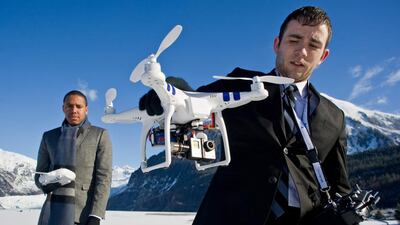 Chris Carson, right, and Lion El Aton of Firefight Films show the gimbaled GoPro video camera attached to the bottom of the DJI Phantom drone quadcopter at Mendenhall Lake in Juneau, Alaska on March 20, 2014. They have been using the unit to film the glacier and an ice cave this winter. Juneau Empire / Michael Penn / AP Photo
