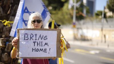 A woman holds a sign demanding the release of Israelis kidnapped by Hamas militants. Bloomberg
