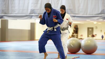 Mahra Al Rwais, in blue, and Balqees Al Hashmi train at Zayed Sports City in Abu Dhabi. Pawan Singh / The National