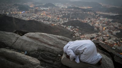 A Muslim worshipper prays on the top of Mount Al-Noor in Mecca, Saudi Arabia. Mast Irham / EPA
